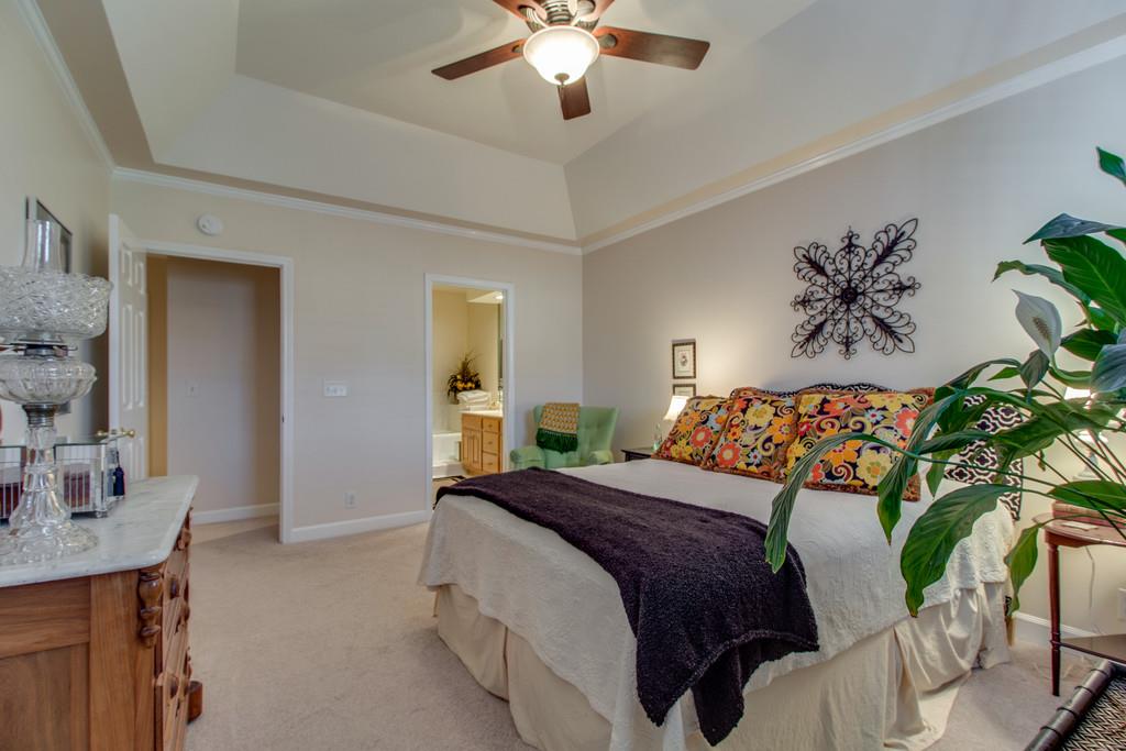 600 General George Patton Road Nashville, TN 37221 - Photo 11 of 18 a bedroom with a large bed and a chandelier