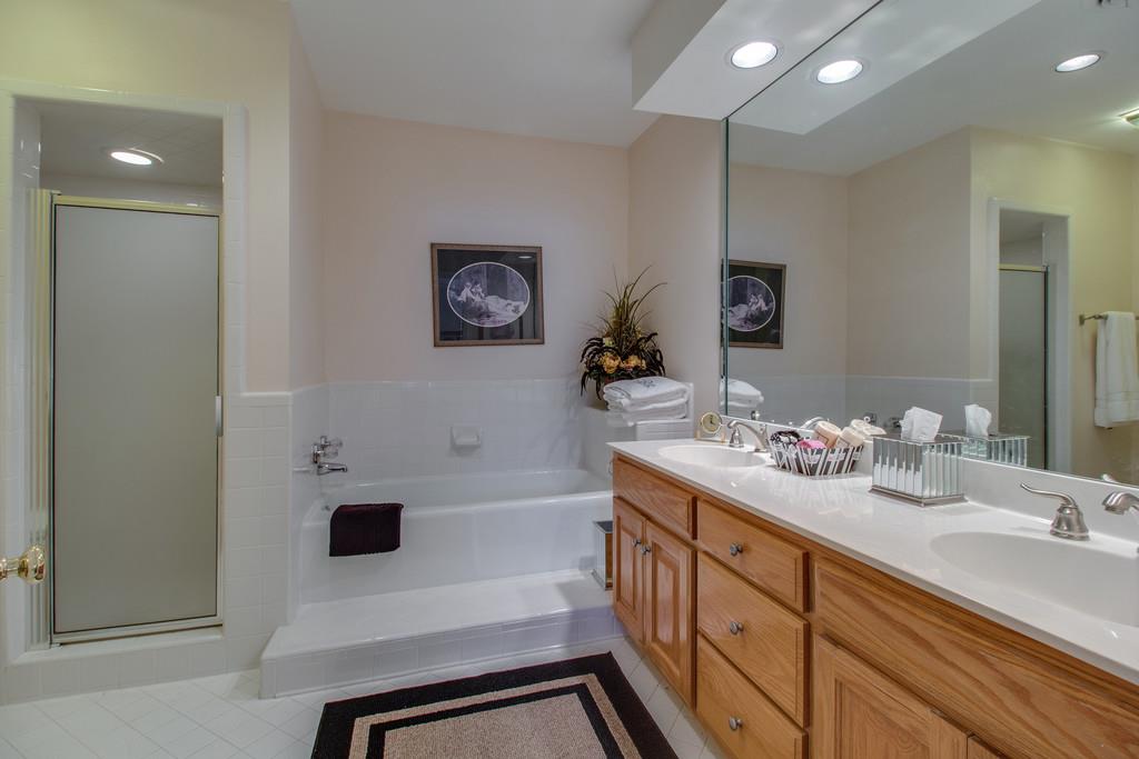 600 General George Patton Road Nashville, TN 37221 - Photo 12 of 18 a bathroom with a double vanity sink a mirror and a bathtub