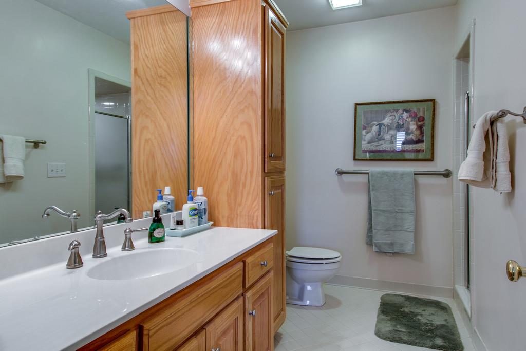 600 General George Patton Road Nashville, TN 37221 - Photo 15 of 18 a bathroom with a sink a toilet and a large mirror