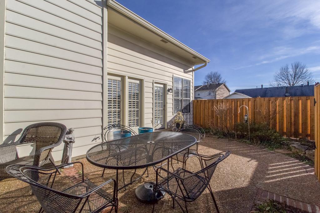 600 General George Patton Road Nashville, TN 37221 - Photo 17 of 18 a backyard of a house with table and chairs