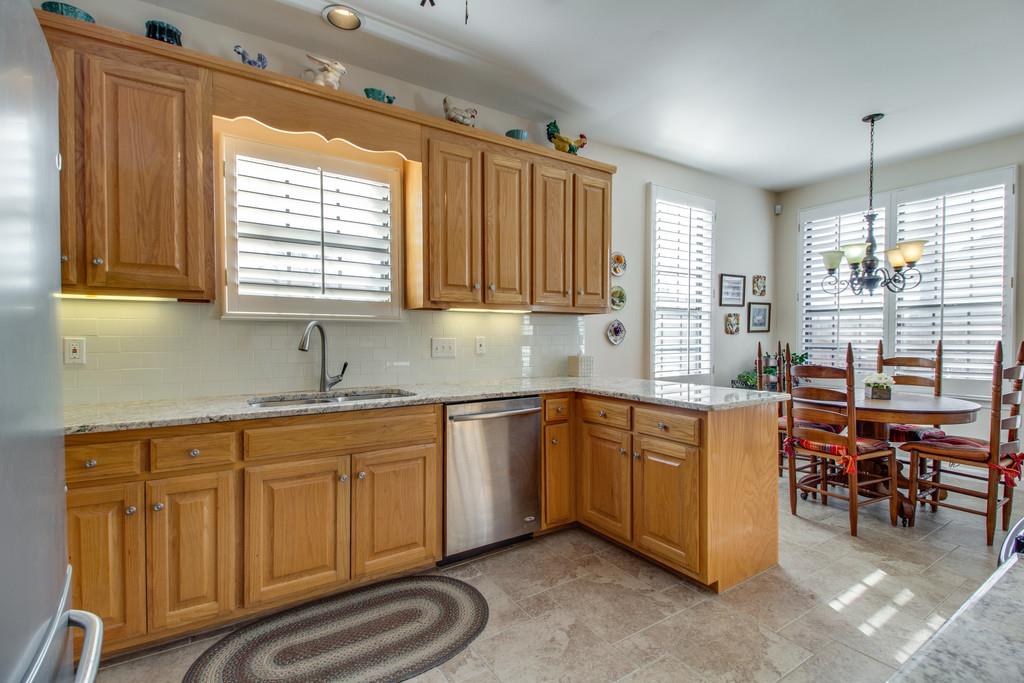 600 General George Patton Road Nashville, TN 37221 - Photo 5 of 18 a kitchen with sink cabinets and dining table chair