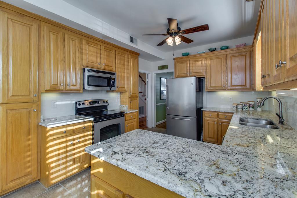 600 General George Patton Road Nashville, TN 37221 - Photo 6 of 18 a kitchen with stainless steel appliances granite countertop a refrigerator a stove top oven a sink and dishwasher