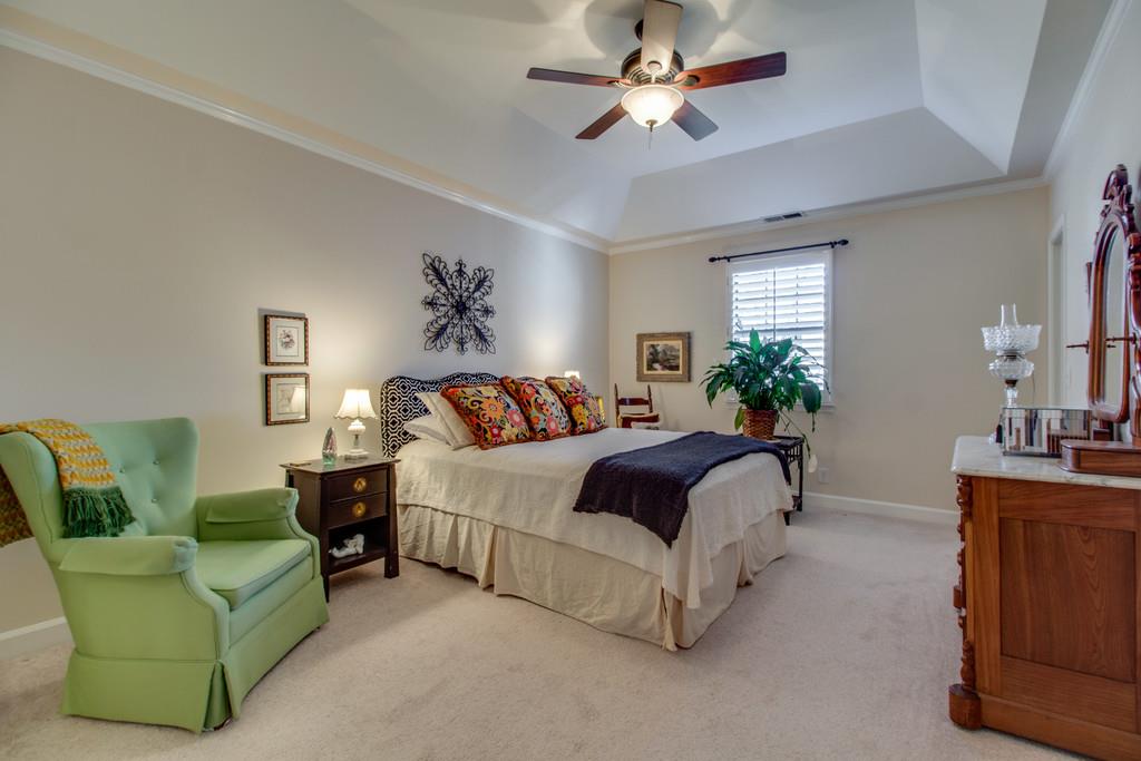 600 General George Patton Road Nashville, TN 37221 - Photo 10 of 18 a spacious bedroom with a bed couch and windows