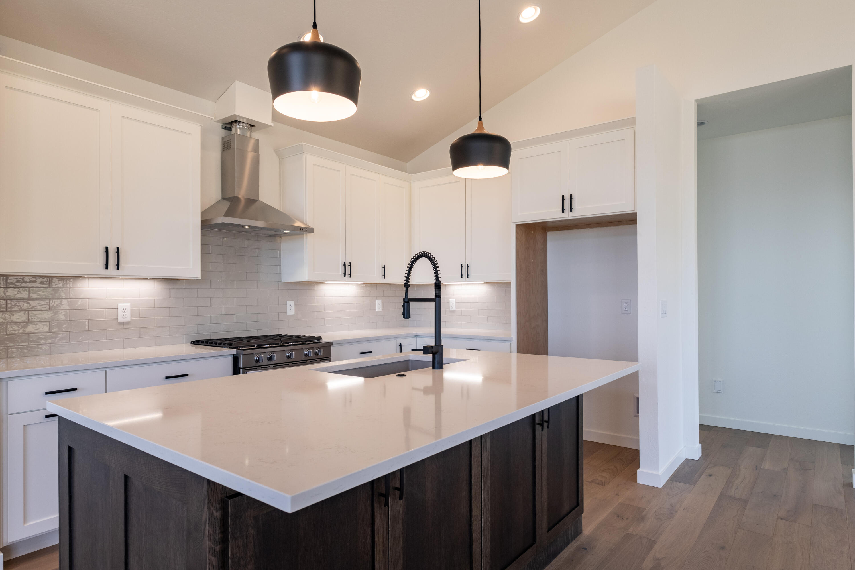 5607 Colver Road Talent, OR 97540 - Photo 3 of 34 a kitchen with stainless steel appliances a sink a center island a stove and a wooden floor