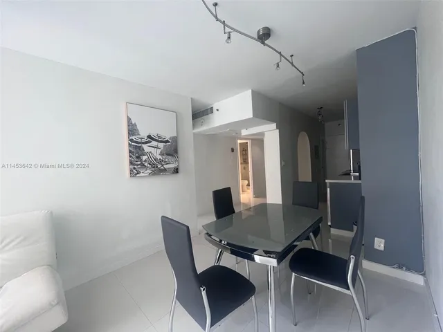 a view of a dining room with furniture and a chandelier