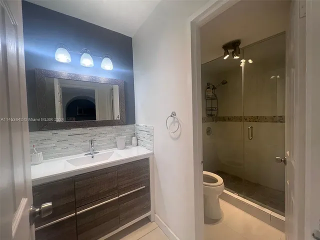 a bathroom with a toilet sink and shower