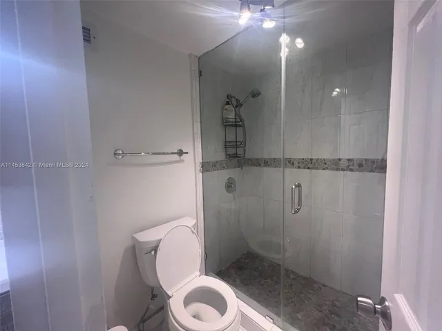 a bathroom with a toilet and a shower