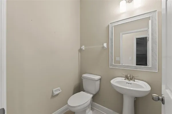 an empty room with windows and ceiling fan