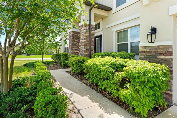 a large kitchen with stainless steel appliances kitchen island granite countertop a stove top oven a sink a counter space and cabinets