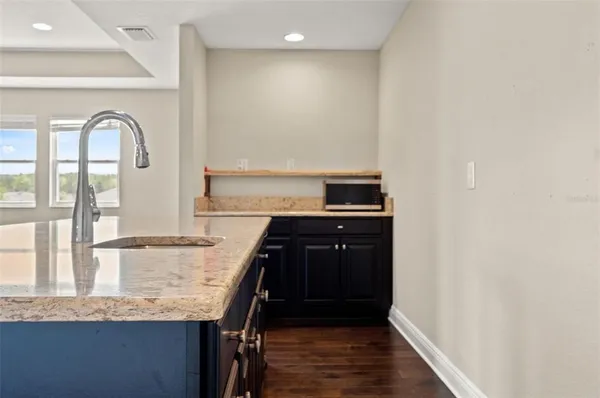 a spacious bathroom with a granite countertop sink toilet and shower
