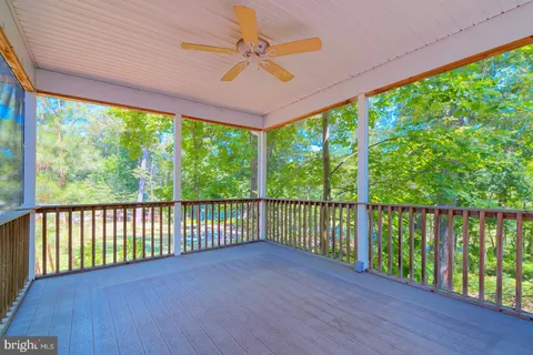 a view of a balcony with floor to ceiling windows with wooden floor