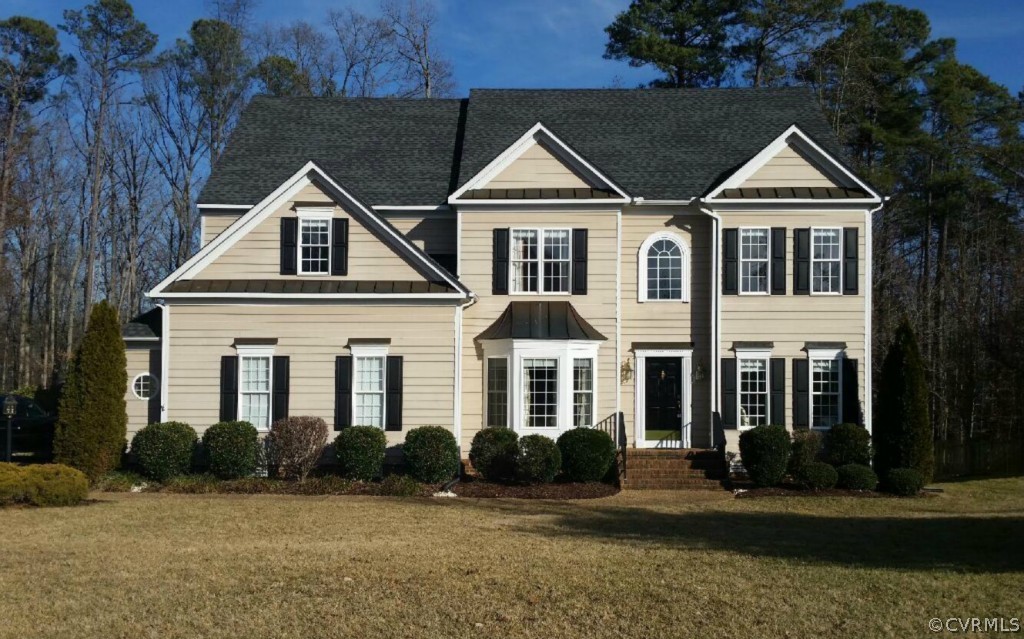 a front view of a house with a yard