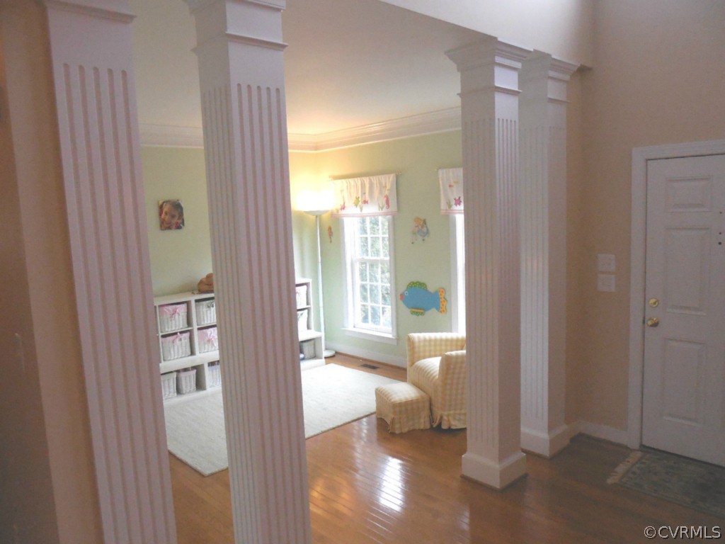 13213 Tipple Point Road Midlothian, VA 23114 - Photo 3 of 24 a view of a hallway with wooden floor and windows