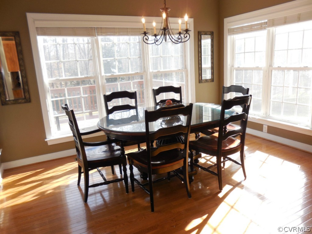 13213 Tipple Point Road Midlothian, VA 23114 - Photo 7 of 24 a view of a dining room with furniture wooden floor and chandelier