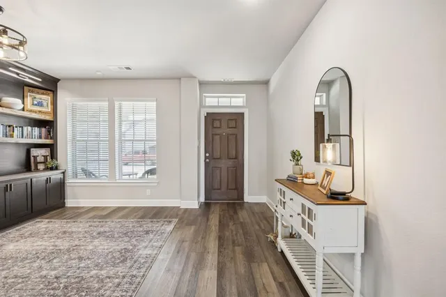 a view of a bedroom with furniture and windows