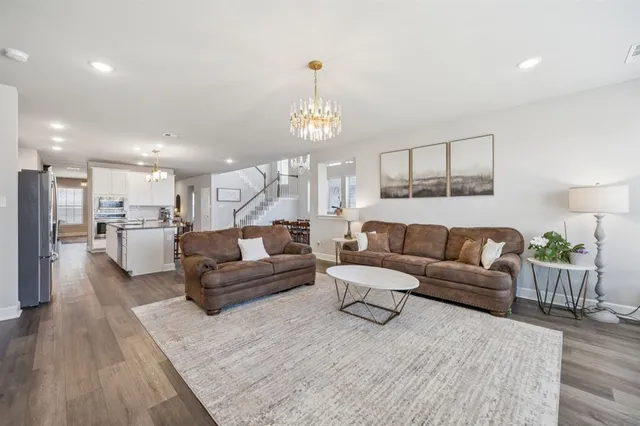 a living room with furniture and a chandelier