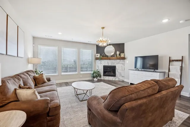a living room with furniture fireplace and flat screen tv