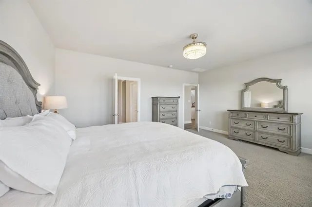 a bedroom with a bed and a dresser