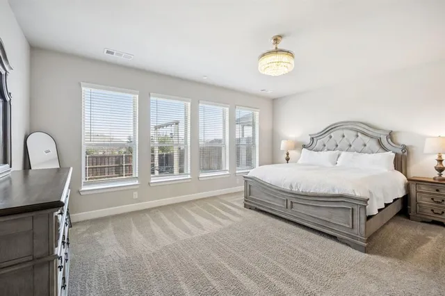 a bedroom with a bed and a large window