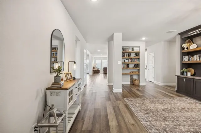 a view of a living room with furniture and wooden floor