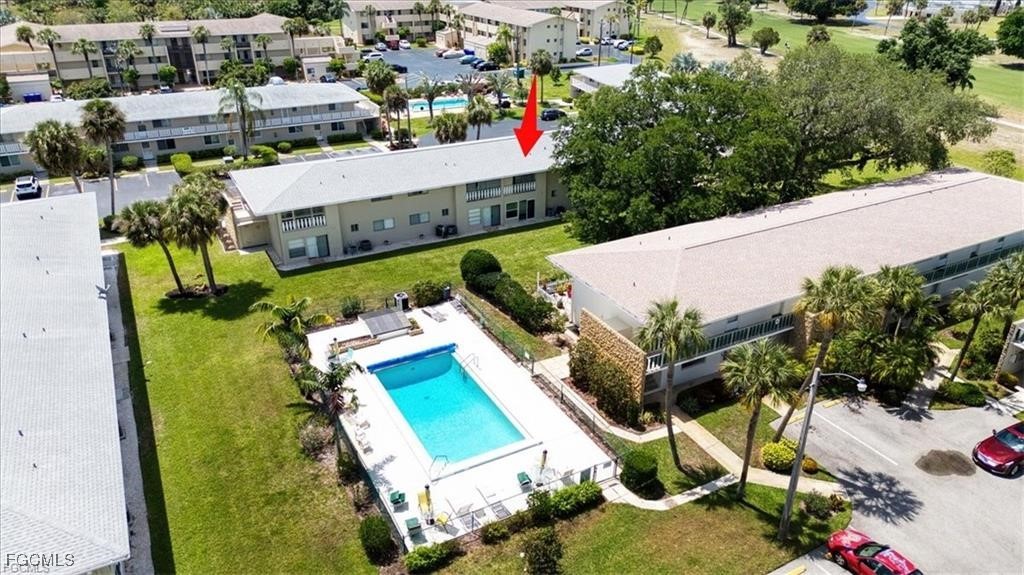 an aerial view of a house with a yard and lake view