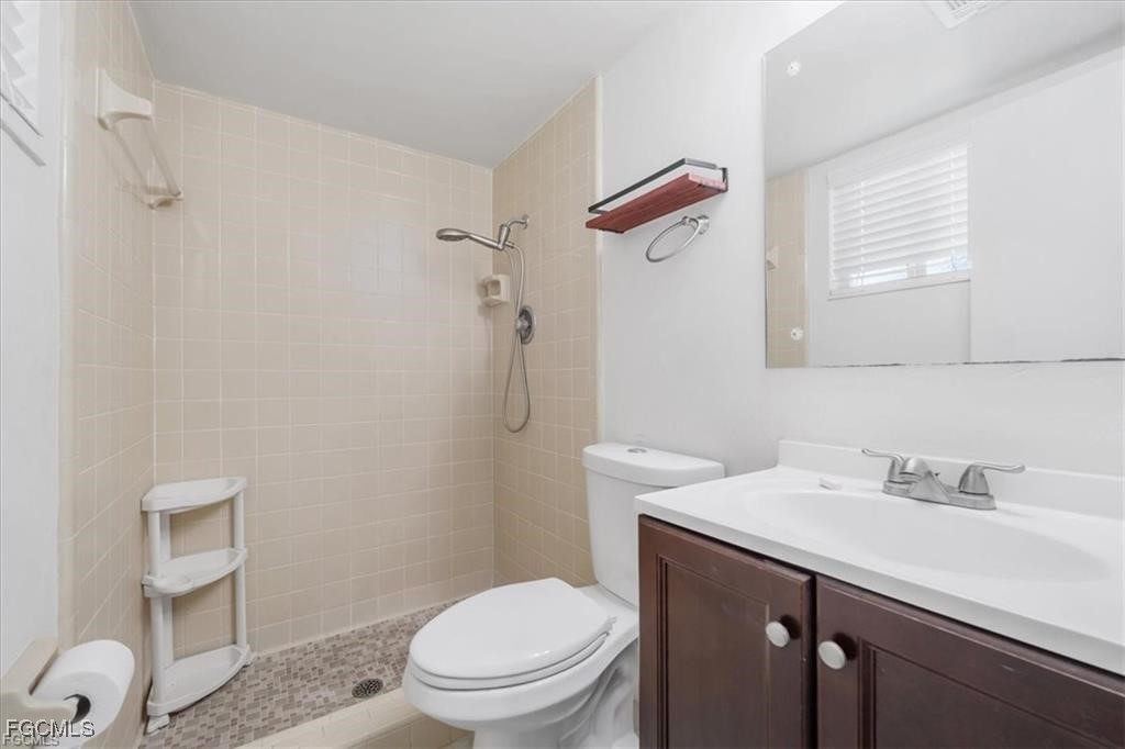 339 Joel Boulevard, Unit 121 Lehigh Acres, FL 33936 - Photo 12 of 40 a bathroom with a sink a toilet and shower