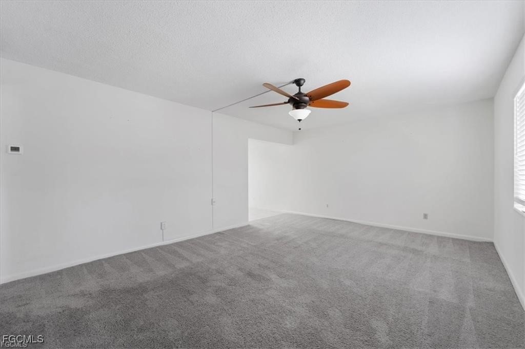339 Joel Boulevard, Unit 121 Lehigh Acres, FL 33936 - Photo 17 of 40 an empty room with a window and a ceiling fan