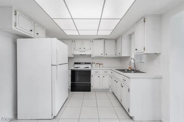a kitchen with stainless steel appliances a refrigerator sink and cabinets