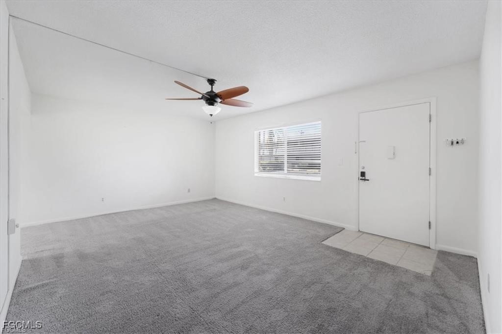 339 Joel Boulevard, Unit 121 Lehigh Acres, FL 33936 - Photo 2 of 40 an empty room with windows and fan