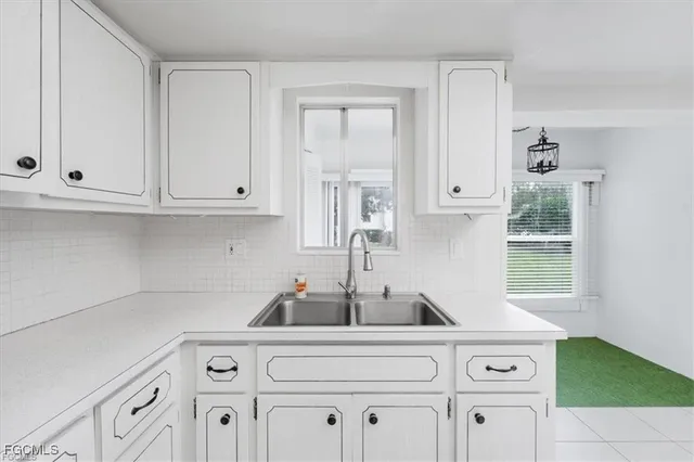 a kitchen with cabinets a stove and a window