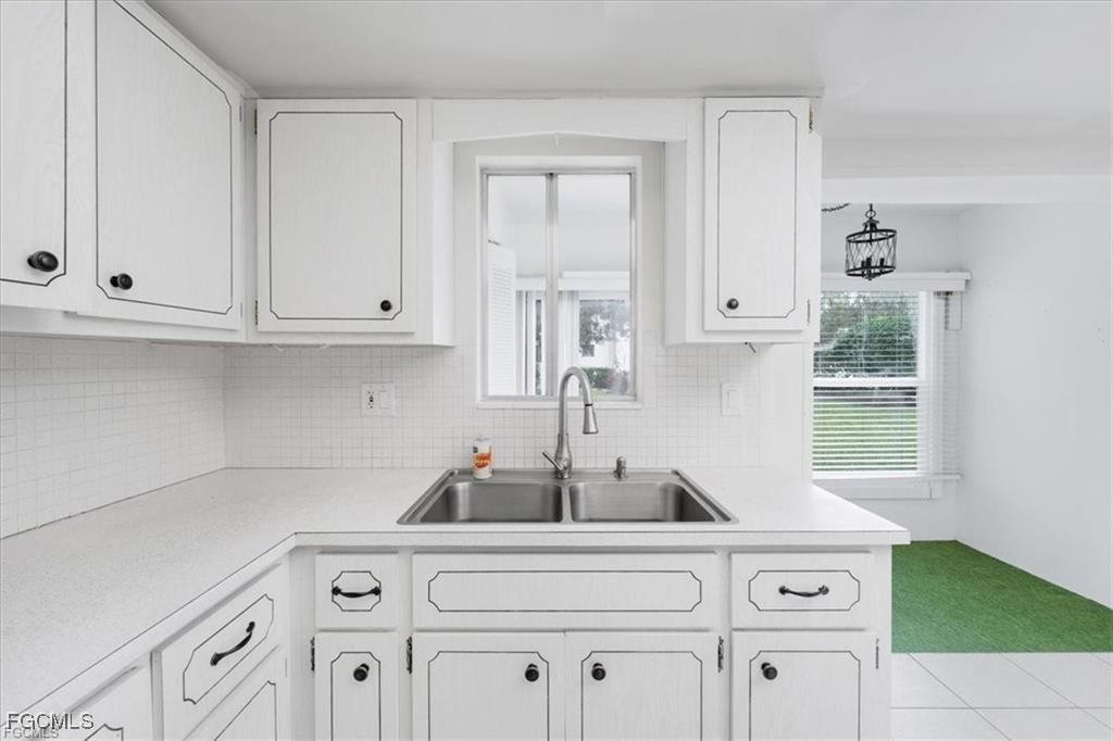 339 Joel Boulevard, Unit 121 Lehigh Acres, FL 33936 - Photo 22 of 40 a kitchen with cabinets a stove and a window