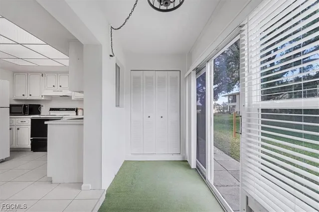 a kitchen with a refrigerator and white cabinets