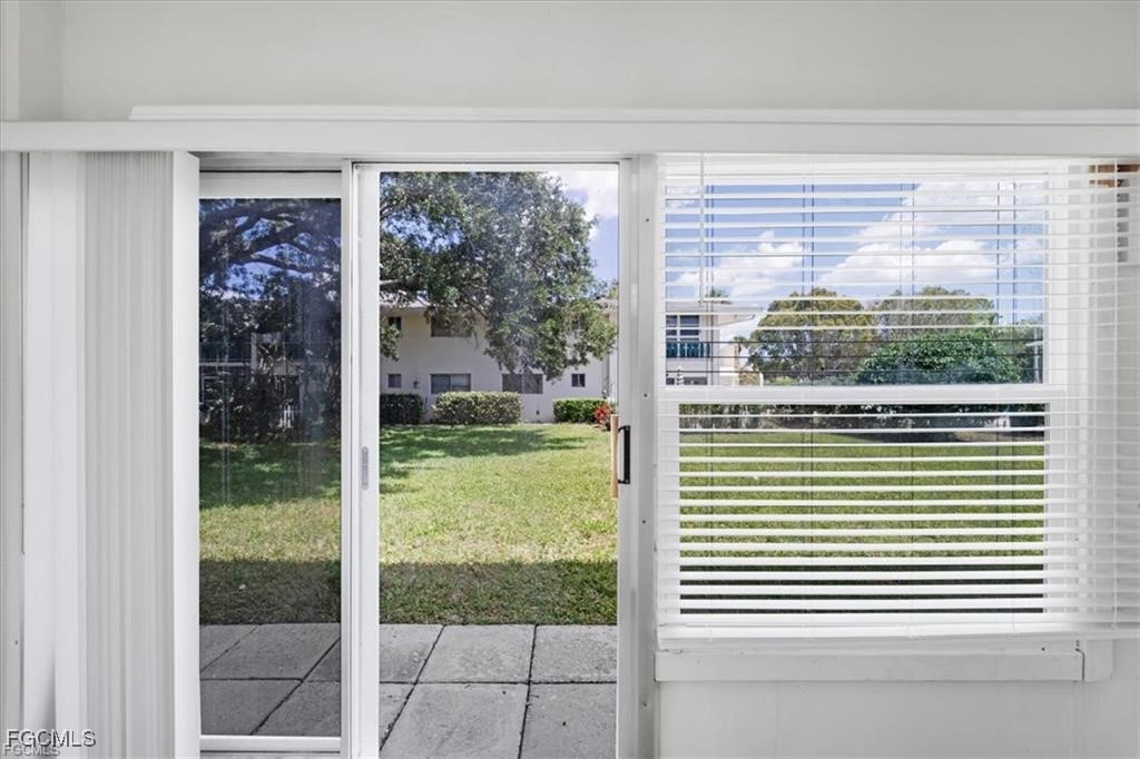 339 Joel Boulevard, Unit 121 Lehigh Acres, FL 33936 - Photo 28 of 40 a view of a room that has a large window and a yard