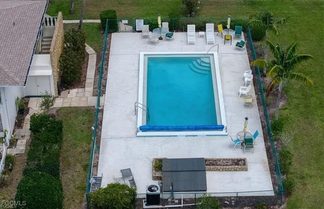 an aerial view of a house with a yard and lake view