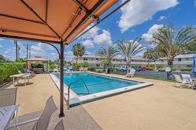 a swimming pool with outdoor seating and yard
