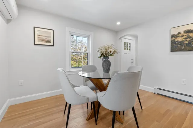 a view of a dining room with furniture and wooden floor