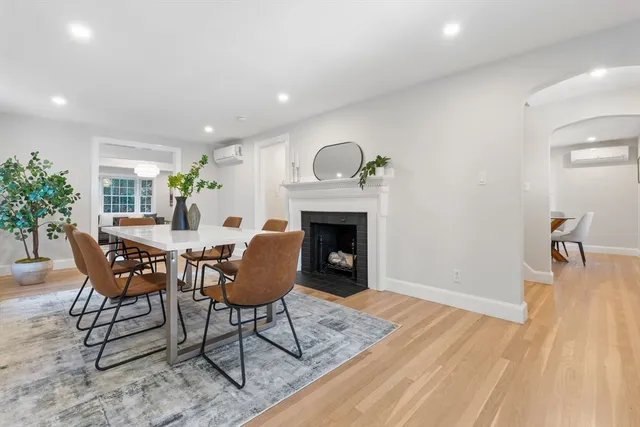 a living room with furniture a fireplace and a table