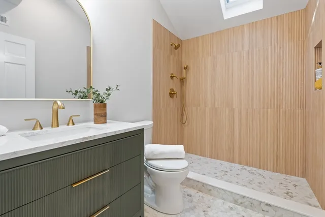 a bathroom with a sink a toilet and shower curtain
