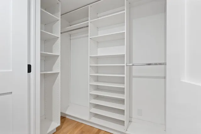a view of walk in closet with empty racks