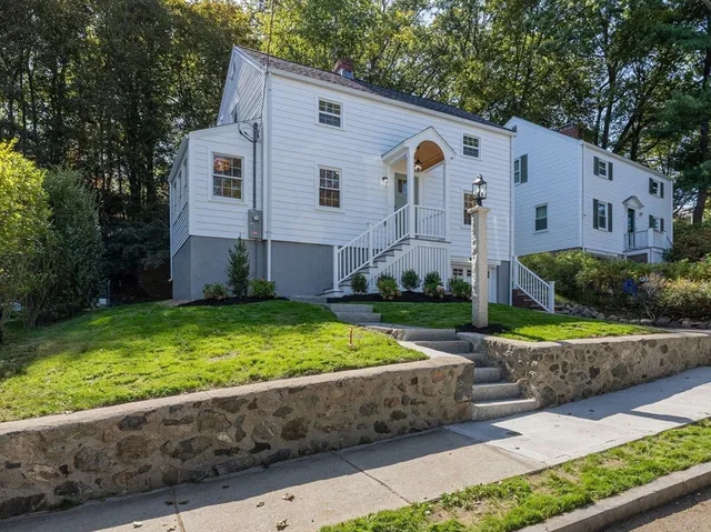a front view of house with yard and green space