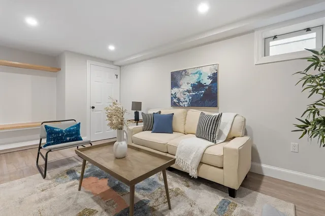 a living room with furniture and a potted plant