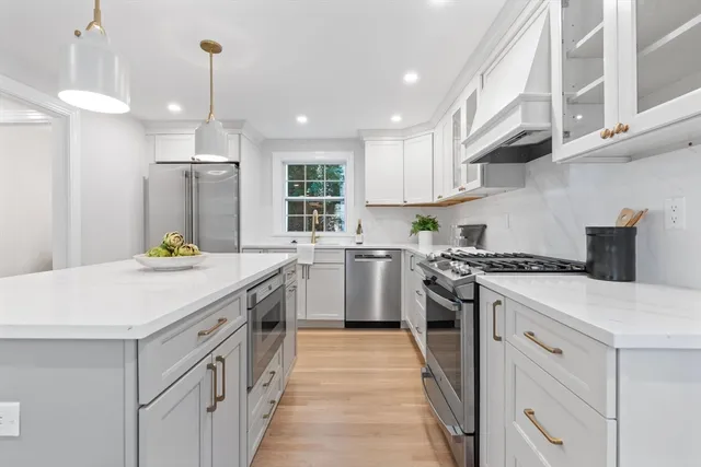 a kitchen with a stove sink and cabinets
