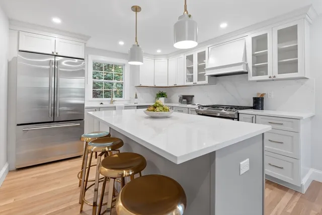 a kitchen with a sink stainless steel appliances and cabinets