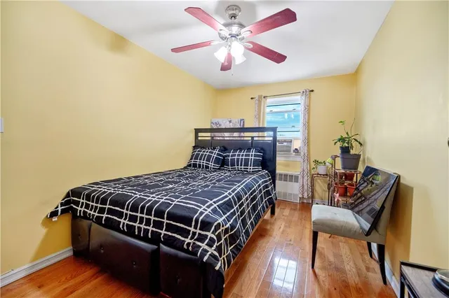 a bedroom with bed and wooden floor