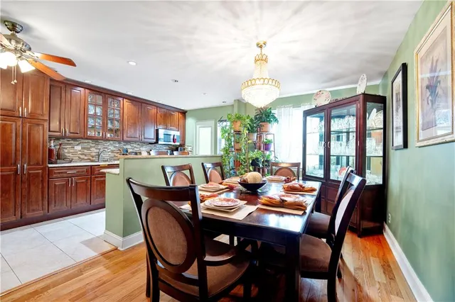 a dining room with furniture a kitchen view and a chandelier