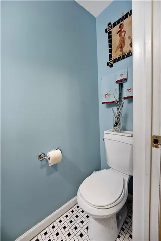 a white toilet sitting next to a bathroom sink