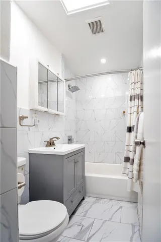 a bathroom with a sink a toilet and bathtub