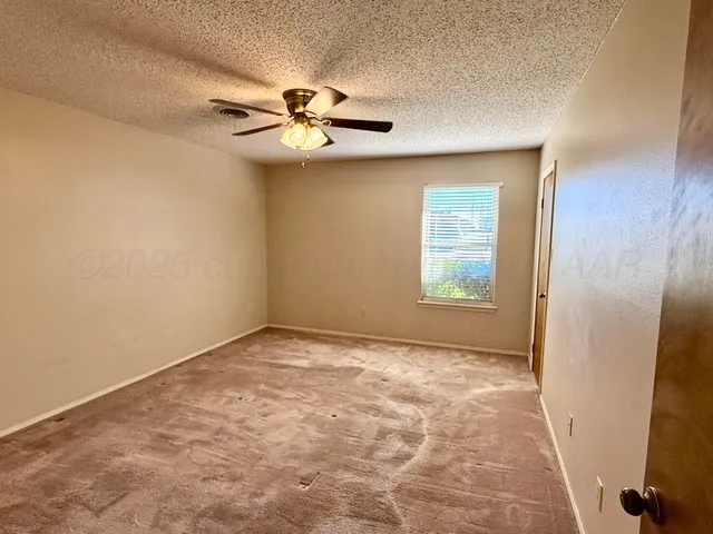 a bathroom with a granite countertop toilet sink and mirror