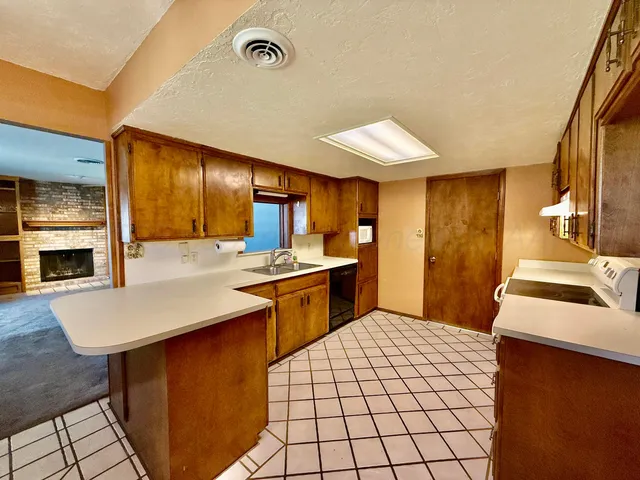 a kitchen with stainless steel appliances a sink stove and cabinets