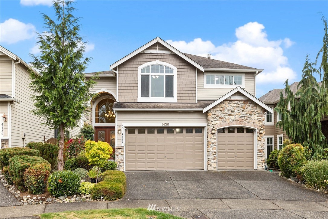4124 215th Street Southeast Bothell, WA 98021 - Photo 1 of 30 a front view of a house with a garden